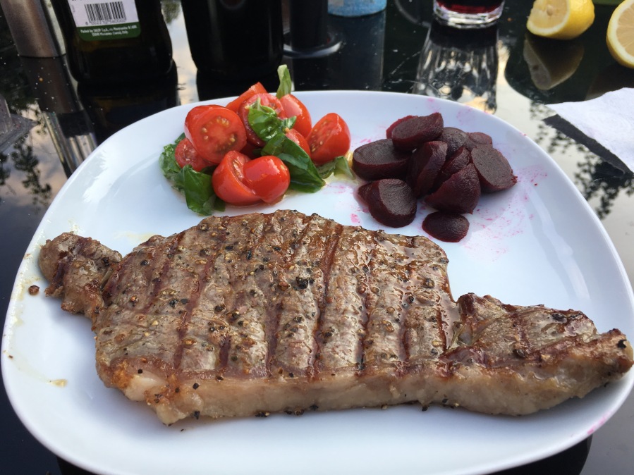 Grilled sirloin steak with tomato salad and spicy beetroot